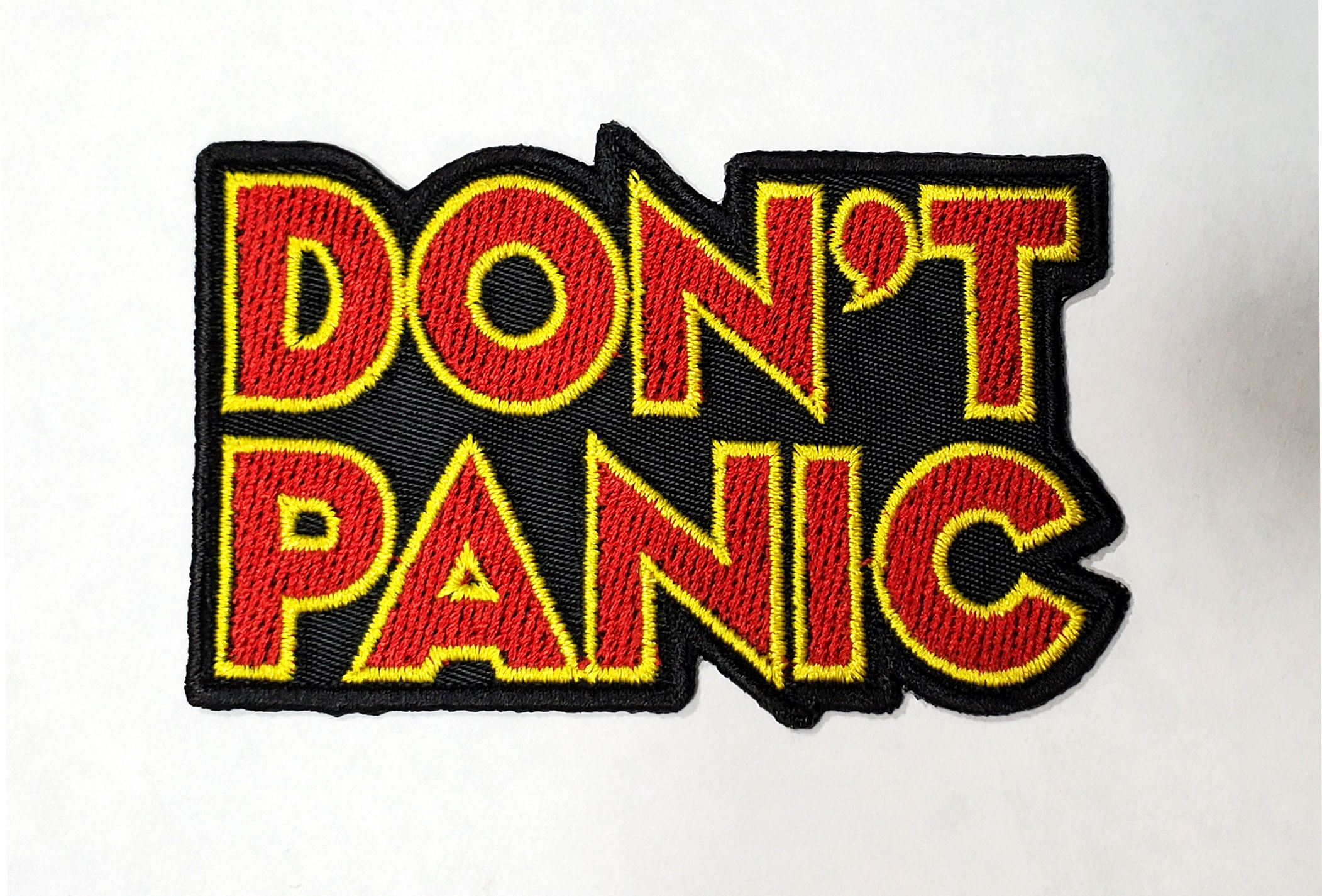 File:Don't Panic Badge.jpg - Wikimedia Commons